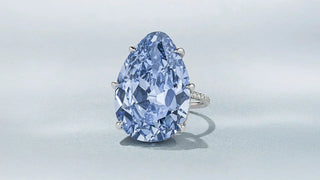 A radiant blue diamond set in an ornate royal-style ring, symbolizing the historic legacy of the Golconda mines.