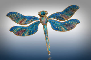 Close-up of colorful enamel jewelry pieces showcasing vibrant hues, intricate hand-painted designs, and detailed craftsmanship—highlighting the timeless artistry behind this resurging trend.