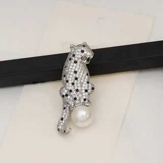 Copper and silver Panther On The Pearl Brooch with lab-created sapphires draped on a luminous pearl, measuring