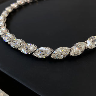 Marquise Cut Necklace featuring a lab sapphire in a marquise-shaped setting, crafted in 925 sterling silver with a delicate chain, displayed against a neutral backdrop.