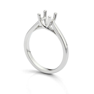 Close-up of an empty gold ring setting without a stone, highlighting a unique engagement ring mount ready for a diamond upgrade.