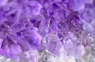 Side-by-side comparison of an amethyst and a purple sapphire engagement ring, highlighting color, brilliance, and gemstone clarity.
