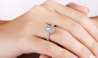 Diamond ring with a halo setting that enhances size appearance, reflecting tips to make a diamond look larger.