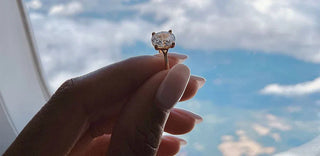 A travel jewelry case with secured diamond pieces, passport, and boarding pass on a suitcase, highlighting safe diamond travel practices.