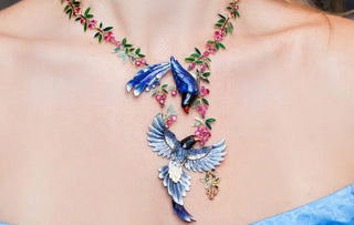 Colorful enamel jewelry pieces on a workbench beside tiny brushes and enamel powders, showcasing traditional techniques and modern trends.