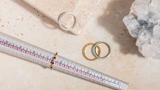 Jeweler carefully resizing a gold ring using professional tools