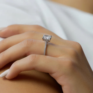 Elegant pavé-set diamond engagement ring with tiny diamonds encrusted along the band, shown in close-up detail.