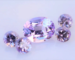 Lilac purple color-changing spinel gemstone displayed under different lighting, showing its vibrant hues and brilliance in a fine jewelry setting.