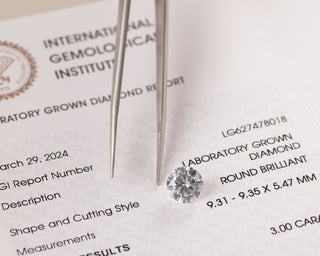 A close-up of diamond certificates for both lab-grown and natural diamonds, showcasing the grading and certification differences.