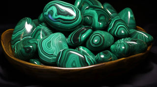 Raw malachite gemstone showing natural banded green patterns.