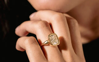 Cushion-cut diamond ring showcasing its vintage-inspired sparkle and soft edges.