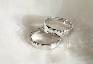 Side-by-side comparison of white gold and platinum diamond rings, highlighting differences in color and finish.