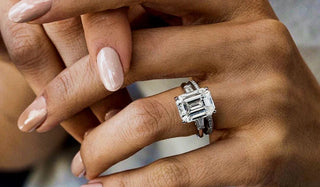 Emerald cut diamond engagement ring with baguette side stones, paired with a matching wedding band.