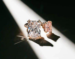 Three gemstones labeled simulant, lab-grown, and natural diamond side by side on a display tray, illustrating their visual similarities and differences.
