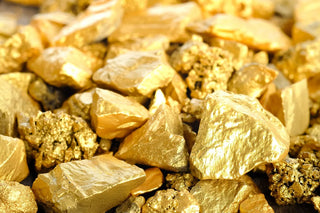 Men manually extracting gold ore in a politically unstable mining region.