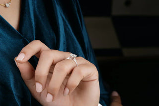 Close-up of a cathedral setting engagement ring, showing the raised arches that elegantly lift the diamond above the band.