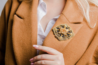 Elegant brooch pinned on a blazer, highlighting how to style brooches as a modern and underrated jewelry statement.