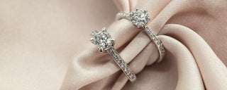 A jewelry box with real gold and diamond pieces stored safely inside, while simpler accessories are laid out for daily wear.