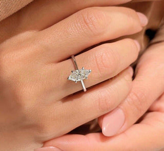 Close-up image of a genuine marquise-cut diamond being tested for authenticity with a jeweler’s loupe.