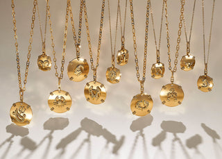 Zodiac-themed jewelry pieces arranged with birthstones, blending astrology with personal style and celestial influence.