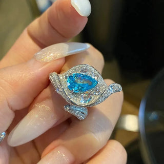 Blue Mirage aquamarine wedding and seal ring in 925 silver with lab sapphire side stones and prong setting
