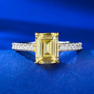 Sterling silver ring with an emerald-cut moissanite centerpiece in a classic prong setting, showcasing minimalist elegance.