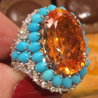 Azzallure Fire and Frost Ring in sterling silver featuring a fiery orange lab sapphire center, surrounded by icy turquoise and lab sapphires—unisex cocktail ring with elemental contrast.
