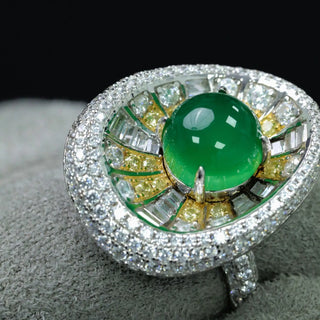 Sterling silver sunburst ring featuring a central jade stone with radiating yellow and white lab sapphires in a vibrant, green statement design.