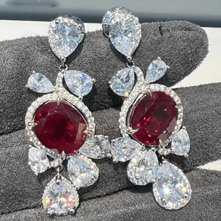 Ruby Waltz Jhumka earrings in 925 sterling silver set with lab-made ruby sapphires and side stones.