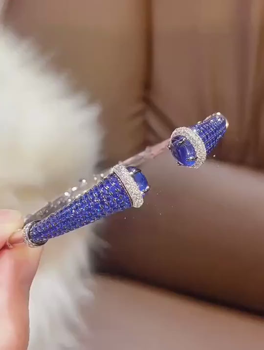 Silver Sapphire Mirage Bangle featuring lab sapphires in a polished silver finish – elegant sapphire bangle bracelet by Azzallure.